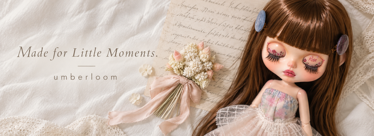 Made for Little Moments — Umberloom. A brown-haired custom doll beside a bouquet, vintage handwritten paper and cream lace.